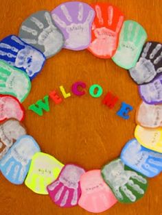 a wreath made out of handprints with the word welcome