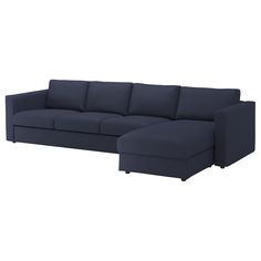 a blue sectional couch sitting on top of a white floor