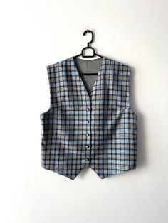 "Vintage Large classic women's vest Wool blend plaid vest Women's formal vest Blue Checkered  Waistcoat Button Up office Vest Estimated size: L Measurements (lying flat): Length: 21\"/ 53.5 cm Pit to pit: 20\"/ 50.7 cm Waist: 20.\"/ 50.7 cm Please check measurements to insure a proper fit. Remember to allow yourself some extra room for movement. You can compare these with something from your closet that fits you well. This vest will come to you freshly laundered and ready to wear. Please convo me if you need additional measurements. Condition: great Vintage Condition SHIPPING * I ship worldwide via Priority mail (Latvijas Pasts) from Latvia (EU). * I ship from Europe, so please allow 2 to 4 weeks for the package to arrive if you live overseas. * Europe 5 - 10 business days. Thanks for the Classic Wool Vest For Office, Business Sleeveless Vest With Buttons, Sleeveless Business Vest With Buttons, Tailored Winter Vest For Office, Tailored Office Vest For Winter, Wool Business Vest With Button Closure, Sleeveless Vest For Business Casual Winter, Fitted Plaid Vest For Winter, Fitted Plaid Sleeveless Vest