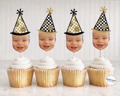 four cupcakes with hats on top of them, all decorated in gold and black