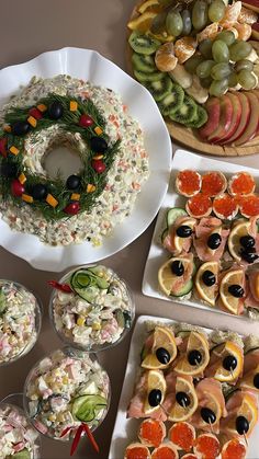 a table topped with plates filled with different types of appetizers and desserts