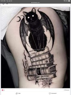 a black cat is sitting on top of some books with bats and stars around it