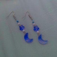 Discover the magic of the night sky with these enchanting handmade dangle earrings, perfect for adding a touch of celestial charm to any outfit! Featuring a vibrant blue crescent moon and star, complemented by delicate white and blue beads, these earrings are lightweight, stylish, and uniquely crafted. 🌙 Whether you're heading to a festival, a casual outing, or simply looking for an everyday accessory with a mystical flair, these earrings are perfect for you! ✨ Special Note: I am excited to ann Blue Crescent Moon, Star Dangle Earrings, Crescent Moon And Star, Handmade Dangle Earrings, Earrings Handmade Dangle, Moon And Star, Everyday Accessories, Blue Outfit, Vibrant Blue