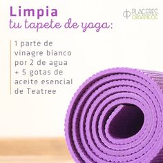 the yoga mat is purple and sits on top of a wooden table with an advertise