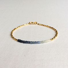 "This is a genuine Ombre Sapphire bracelet made of 2mm Sapphire beads. You can choose to have it made in sterling silver gold plated beads or solid 14k gold beads. The total length for this September Birthstone bracelet is 7\" long. This gemstone bracelet is simple and elegant. The dainty gold bracelet is great to layer with other tiny gold bracelet. In the drop down menu you can choose to have it made in gold plated over sterling silver or 14k solid gold beads. Measurement: 2mm Ombre Sapphire 7 Minimalist Hand-strung Rondelle Bracelets, Minimalist Bracelets With Faceted Rondelle Beads, Minimalist Faceted Beads Rondelle Bracelets, Minimalist Rondelle Bracelets With Faceted Beads, Ombre Bracelet, Dainty Gold Bracelet, Dry Creek, Beads Bracelet Design, Sapphire Bracelet