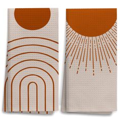 two orange and white towels with an image of a sun in the sky on them