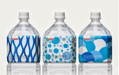 three bottled water bottles with blue and white designs