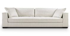 a white couch with two pillows on it