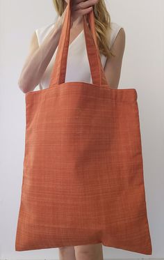 Tote bag with inner bag, made of cotton fabric, finished with bias, your perfect companion for your daily look. Its simple design allows you to carry your essentials comfortably and with style, made with care and attention. 36cm long 44cm high 28cm drop length Eco-friendly Square Canvas Bag For Shopping, Eco-friendly Square Canvas Shopping Bag, Orange Canvas Shoulder Bag For Everyday Use, Orange Cotton Shoulder Bag For Travel, Orange Cotton Travel Shoulder Bag, Orange Everyday Canvas Shoulder Bag, Casual Orange Cotton Shoulder Bag, Orange Tote Bag For Daily Use, Square Orange Bag For Daily Use