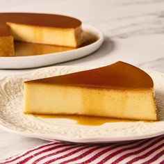 two plates with slices of cheesecake on them and one slice is covered in caramel sauce