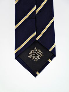 "This is a classic men's navy necktie with gold stripe. Available as a extra long Necktie Handmade from 100% silk, this special collection features a .75\" Eds Neckties logo at the bottom right front corner of every tie and a larger logo located on the tipping (Back of the tie). The label features the collection name (Nathaniel Alexandria) Named after my son Nathaniel and my daughter Alexandria. Expertly hand-made from 100% silk you can select your length from 57\" to 63\" (Great for taller Men) Formal Ties For Father's Day, Classic Ties For Father's Day, Classic Navy Suit And Tie Accessories For Business, Dapper Gold Tie For Business, Classic Gold Tie For Father's Day, Classic Gold Ties For Father's Day, Gold Tie For Father's Day, Classic Gold Tie And Suit Accessories, Classic Gold Suit And Tie Accessories For Black Tie