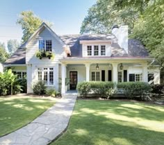 a white house with black shutters on the front and side windows is seen in this google street view