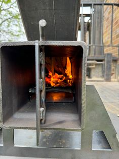 an outdoor oven with fire burning in it