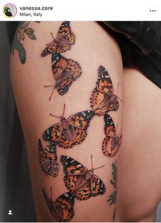 a woman's thigh with butterflies on it