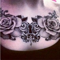 a woman's chest with roses and a key tattoo on it