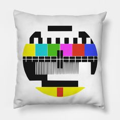 a white pillow with an old tv test pattern on the front and back, in multi - colored squares