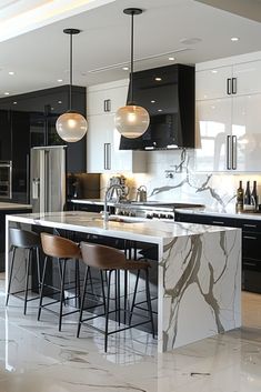 a kitchen with marble counter tops and bar stools next to an island in the middle