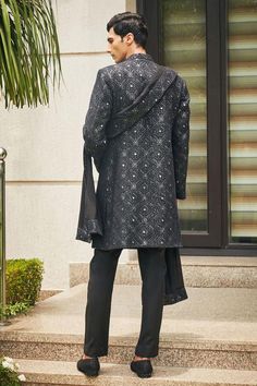 Black sherwani with floral Mughal chikankari embroidery and sequin highlights. Comes with matching dupatta, short kurta and pant.
Components: 4
Pattern: Embroidered
Type Of Work: Chikankari, Sequins
Neckline: Mandarin
Sleeve Type: Straight Full
Fabric: Sherwani and Dupatta- Georgette, Kurta and Pant- Terrywool
Color: Black
Other Details: 
Model height: 6ft, wearing size M
Occasion: Cocktail and Reception - Aza Fashions Black Sherwani, Kurta Set Men, Georgette Kurta, Chikankari Embroidery, Short Kurta, Types Of Work, Kurta Set, Aza Fashion, Model Height