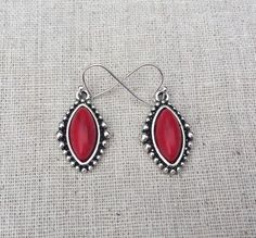 Red howlite stone earrings.  Set in an antique silver plated bezel frame with fun accents that help accentuate the centerpiece.These are lightweight and comfortable to wear.  They hang from a simple sleek silver ear wire hook.  All made from allergy free materials.  Earrings measurements are, 1/2” wide by 7/8” long.  Overall drop length is about 1”.I have a matching necklace in my Etsy shop if you would like the whole set.  Here is the link............... https://etsy.me/2WKmoCF I have this same Southwestern Red Drop Earrings, Red Bohemian Sterling Silver Earrings, Southwestern Red Dangle Earrings, Red Southwestern Dangle Earrings, Southwestern Style Red Dangle Earrings, Nickel-free Southwestern Red Earrings, Nickel-free Red Southwestern Earrings, Southwestern Style Red Nickel-free Earrings, Red Stone Earrings