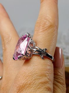 Simulated Pink Topaz Ring Luv Design#109 Custom Made This is a brand new Victorian/Art Nouveau inspired in solid sterling silver. The gorgeous filigree ring is set with a 13ct Man-made/Simulated pink topaz. The rectangular cushion-cut gem is 18mm (just shy of 3/4th of an inch) by 13mm (1/2 inch) in size. The inside of the band is marked 925 for solid sterling. Notice the intricate and detailed leaf floral design of the silver filigree setting. A gift-box is included for safe keeping. Feel free t Silver Solitaire Ring Gemstone, Wedding Silver Topaz Gemstones, Sterling Silver Solitaire Gemstones For Anniversary, Silver Heart Cut Topaz Ring, Pink Sterling Silver Gemstones For Anniversary, Silver Emerald Cut Gemstones With Accent Stones, White Gold Sterling Silver Topaz Ring, Pink Topaz Ring In Sterling Silver With Prong Setting, Sterling Silver Topaz Anniversary Ring