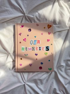 a pink book with the words our memories written in multicolored letters on it