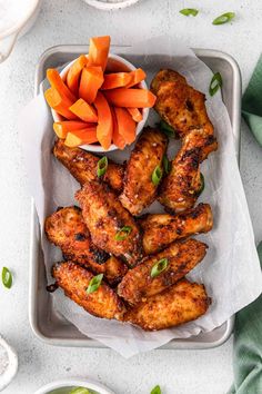 chicken wings with carrots and celery on a tray