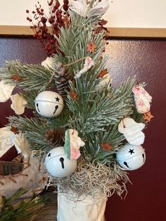 a white vase filled with ornaments on top of a table