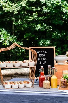 a table topped with hot dogs and condiments