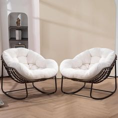 two chairs sitting next to each other on top of a hard wood floored floor