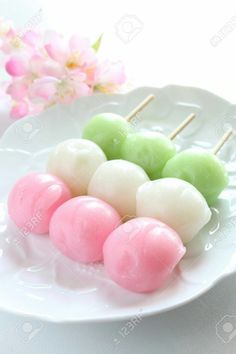 small marshmallows on a white plate with pink and green flowers in the background