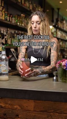 a woman sitting at a bar in front of a bottle and a glass with the words, the best cocktail you've never heard of