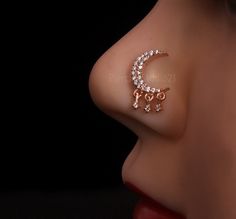 a close up view of a nose with the moon and stars on it's side