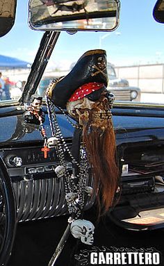 the interior of a car is decorated with skulls and other things, including a pirate's head