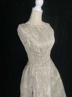 "Fabulous 1960's metallic silver and white Emma Domb formal dress with low back and high neckline. Zipper up the back and tulle under the skirt to help keep it full. Skirt near the hem has an orange spot about the size of a quarter Women's small/medium 36\" bust 27\" waist Open hips 60\" shoulder to hem" Metallic Dresses For Wedding And Prom Season, Fitted Metallic Evening Dress For Wedding, Metallic Fitted Dress For Wedding, Vintage A-line Wedding Evening Dress, Silver Vintage Dress For Formal Occasions, Vintage Silver Wedding Dress, Silver Vintage Wedding Dress, Vintage White Evening Dress For Party, Silver Vintage Dresses For Formal Occasions