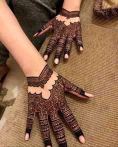 two hands with henna designs on them