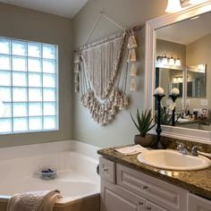 a bath room with a sink and a bath tub next to a mirror on the wall