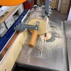 a piece of wood being cut by a machine