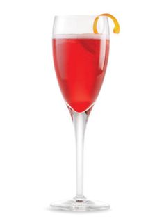 a wine glass filled with red liquid and an orange peel on the rim, isolated against a white background