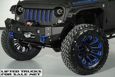 a black jeep with blue wheels and tires