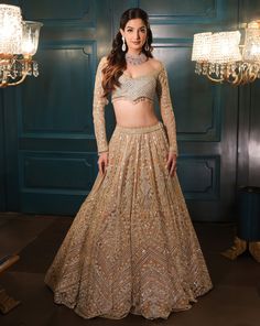 This lehenga set is hand embroidered in floral and geometric motis with a mix of light gold and sequin embroidered. Paired with a full sleeves embroidered wide-neck blouse and match dupatta.DELIVERY TIMEPlease allow 8-12 weeks for your outfit to arrive.FABRIC DETAILSNetProfessional cleaning only. Gold Anarkali Set With Long Sleeves, Gold Anarkali Set With Intricate Embroidery And Long Sleeve, Long Sleeve Lehenga With Intricate Embroidery For Eid, Anarkali Style Saree For Reception, Festive Saree With Intricate Embroidery And Long Sleeves, Gold Long Sleeve Anarkali Set With Mirror Work, Gold Long Sleeve Anarkali Set With Resham Embroidery, Gold Long Sleeve Choli With Zari Work, Gold Long Sleeve Lehenga For Festive Occasions