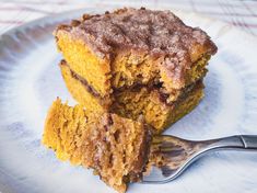 two pieces of cake on a plate with a fork