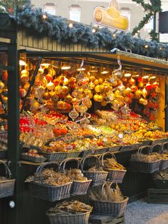 an outdoor market with lots of food on display