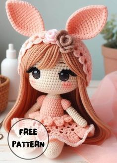 a crocheted doll with long hair and bunny ears sitting on top of a table