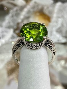 K-Ring (Design#4) Made To Order/Custom This is a brand new Art Nouveau design trellis filigree 5ct to 6ct natural peridot ring in solid sterling silver (Solid 10K and 14K gold option also now available). This full cut natural peridot VS to VVS (AA to AAA) stone is 12mm in diameter.  The inside of the band is marked 925 for sterling (or 10K/14K if gold option selected).  Notice the beautifully intricate design of the filigree setting and trellis band. This is a lovely new, well made, and charming Green Sterling Silver Filigree Ring, Green Gemstone Filigree Ring, Green Gemstone Filigree Ring For May Birthstone, Green Filigree Ring For May Birthstone, Green Rings With Intricate Design, Classic Green Filigree Round Ring, Filigree May Birthstone Ring, Green Oval Filigree Ring, Classic Green Filigree Ring