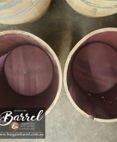 four wine barrels sitting on top of a table