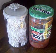 two jars filled with food sitting on top of a wooden table next to each other