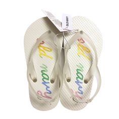 Old Navy Baby Toddler Girl Off White Clear Multicolored Old Navy Rainbow Logo Flip Flops Sandals Summer Shoes Condition: New With Tags May Have Shelf Wear Brand: Old Navy Size: 10 Measurements: *All Are Approximate - Length: 7" - Width: 3" Style Name: Rainbow Colors: Off White, Eggshell, Ivory, Red, Orange, Yellow, Green, Mint Green, Tiffany Blue, Blue, Lavender, Purple, Clear Details: Old Navy Cursive Script Rainbow Colored Logo Print On Top Sole Portion Of Flip Flop; Exterior Is Solid Off Whit Fun White Flip Flops For Vacation, Fun White Sandals For Spring, White Sandals For Summer Playtime, Adjustable White Sandals For Playtime, Playful White Flip Flops For Spring, Playful White Non-slip Sandals, White Synthetic Sandals With Soft Sole, Playful Non-slip White Sandals, White Fun Flip Flops For Spring