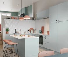 a kitchen with pink chairs and white counter tops