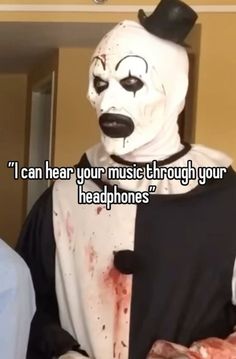 a man wearing a creepy clown mask with the caption i can hear your music through your headphones