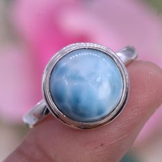 Free Shipping In The UK!! Next Day Dispatch!! The ring is solid 925 Sterling Silver Ring with the stone larimar with beautiful blue colour. The setting adds beauty and flair to the item. The ring is adjustable from UK size K to U. Metal - 925 Sterling Silver Metal Purity - 92.5% Solid Silver  Measurements: Stone Size: 6 mm Ring Weight: 3.7 grams About the Stone: Larimar is an earth-healing stone.  It connects with nature and will counteract imbalances in the earth's energy. Larimar helps to heal Larimar Turquoise Ring Gemstone Gift, Larimar Turquoise Ring Gift, Turquoise Larimar Ring Gift, Blue Larimar Jewelry For Anniversary, Gift Turquoise Larimar Ring, Blue Moonstone Sterling Silver Ring Gift, Blue Moonstone Ring In Sterling Silver As Gift, Blue Larimar Round Rings, Handmade Blue Turquoise Larimar Ring